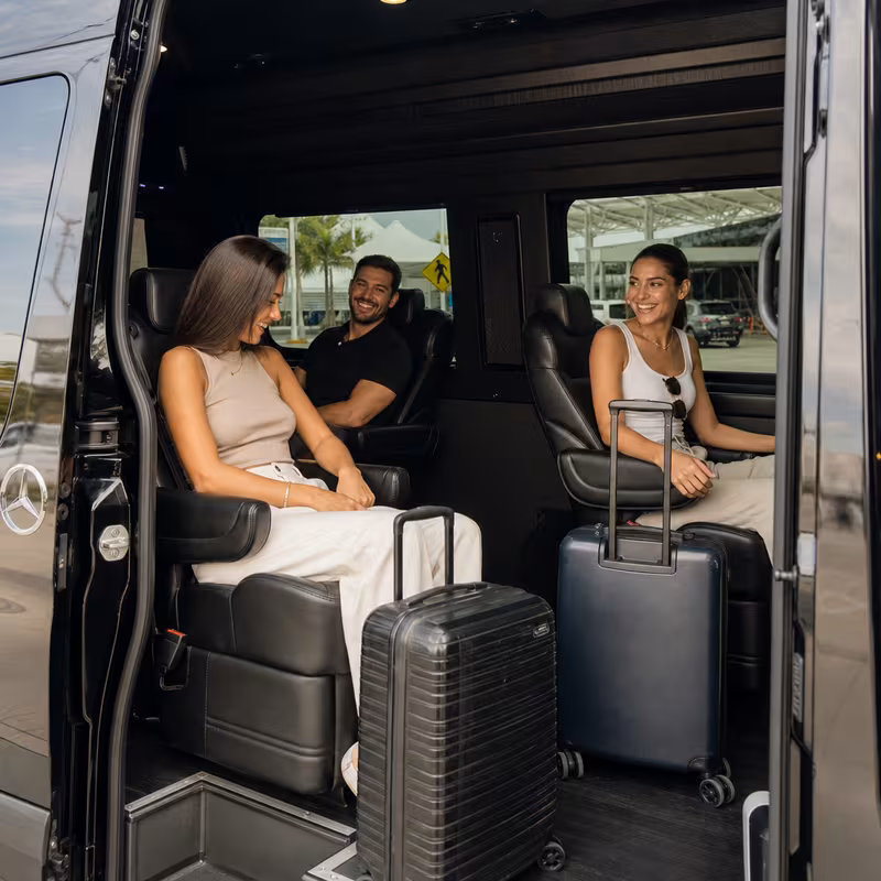 Passengers loading luggage while boarding an Boca Raton group shuttle
