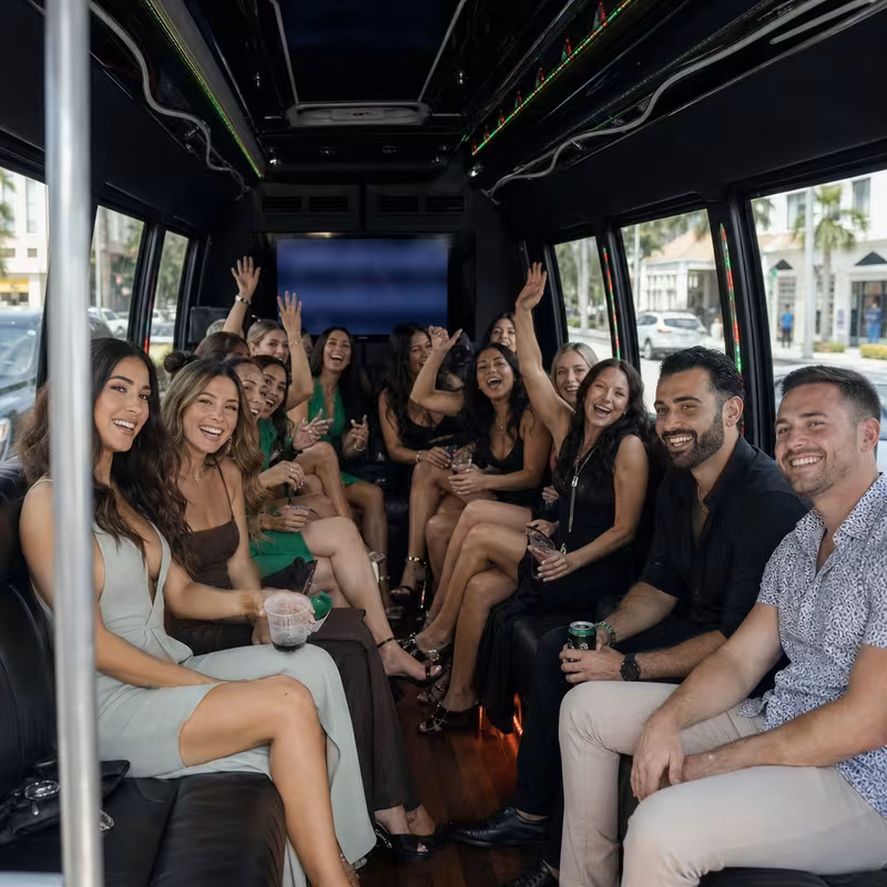 Party bus interior with wraparound leather seating and LED lighting in Boca Raton