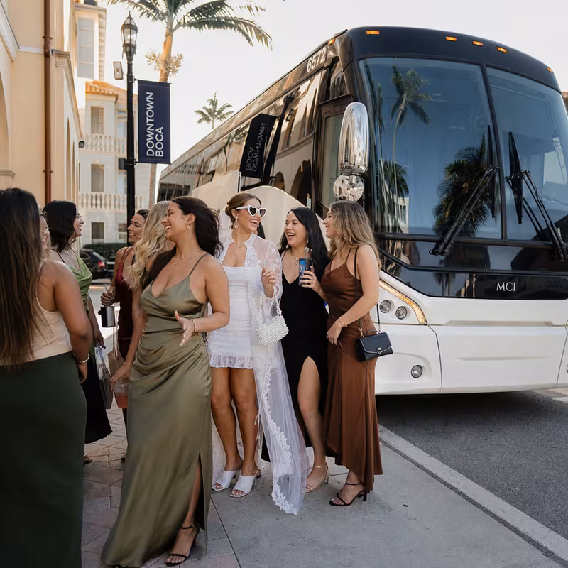 Passengers loading luggage while boarding an Boca Raton group shuttle
