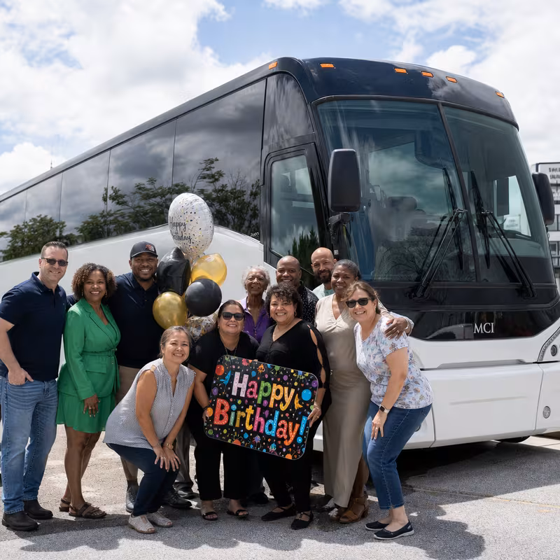 Passengers loading luggage while boarding an Boca Raton group shuttle