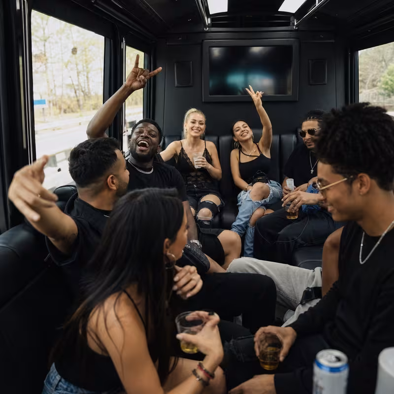 Group boarding a white charter bus for Concert Transportation transportation in Boca Raton