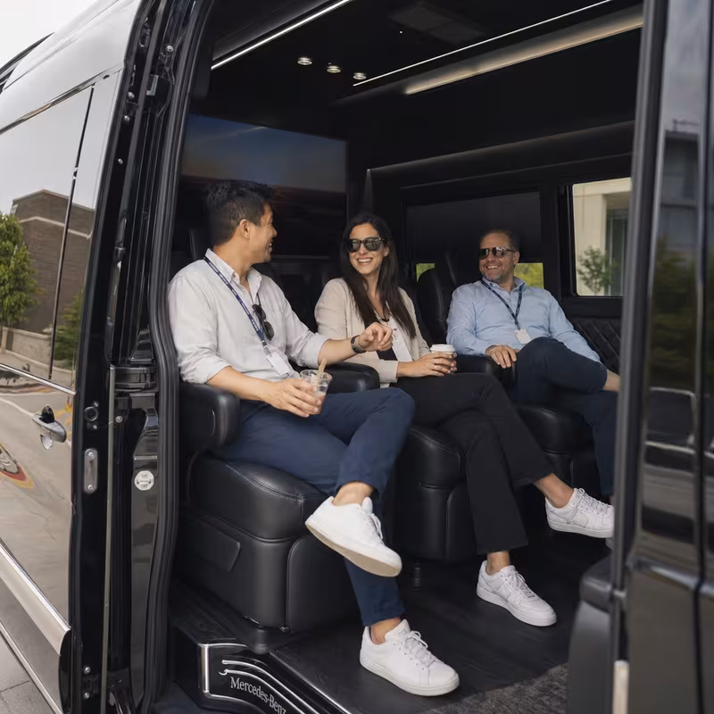Group boarding a white charter bus for Corporate Transportation transportation in Boca Raton