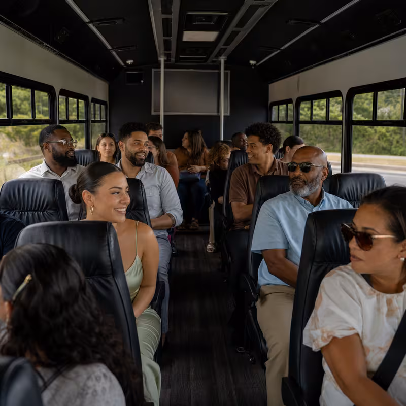 Group boarding a white charter bus for Private Event Transportation transportation in Boca Raton
