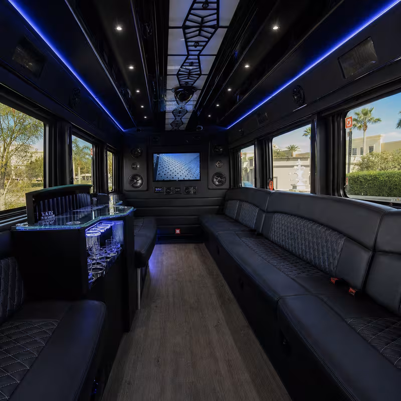 Party bus interior with wraparound leather seating and LED lighting in Boca Raton