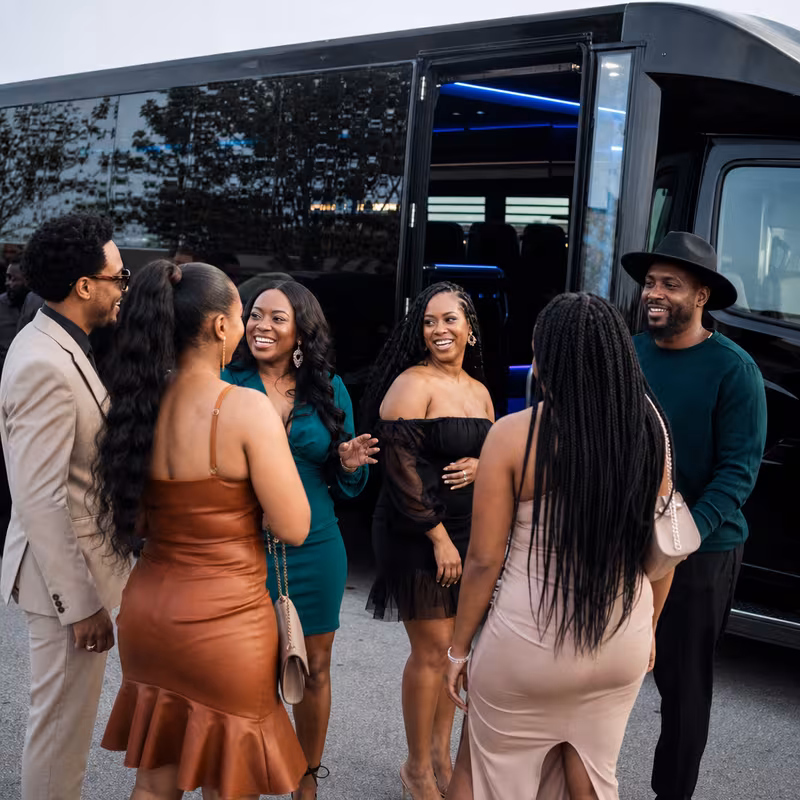 Passengers loading luggage while boarding an Boca Raton group shuttle