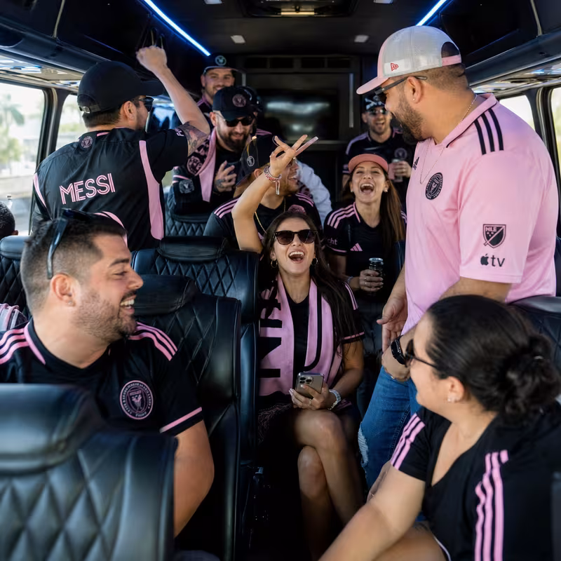 Group boarding a white charter bus for Sporting Event Transportation transportation in Boca Raton