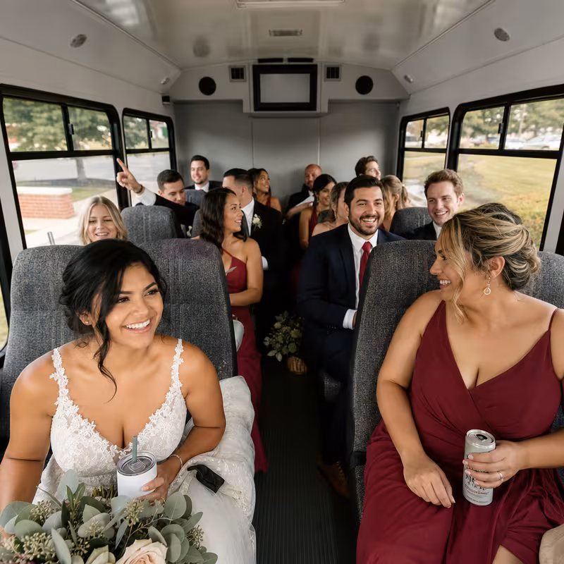 Group boarding a white charter bus for Wedding Transportation transportation in Boca Raton