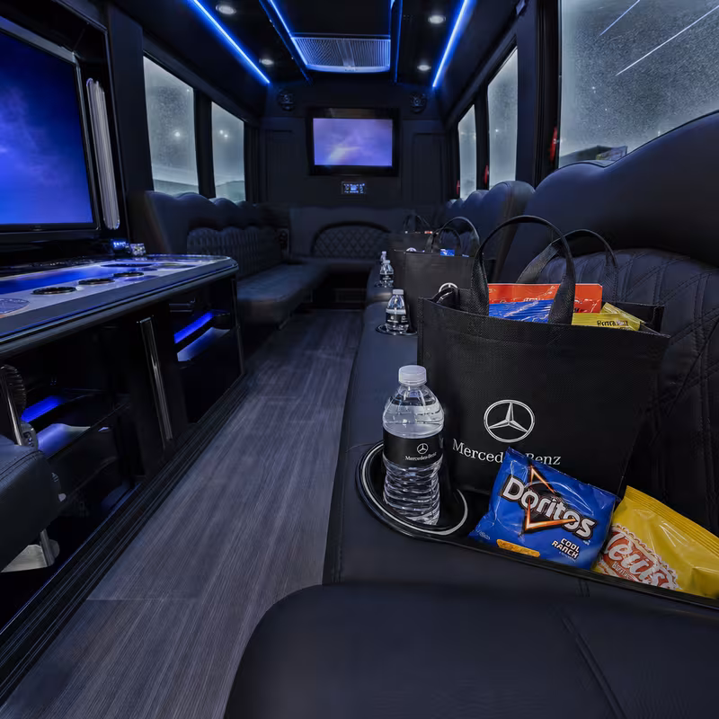 Party bus interior with wraparound leather seating and LED lighting in Boca Raton